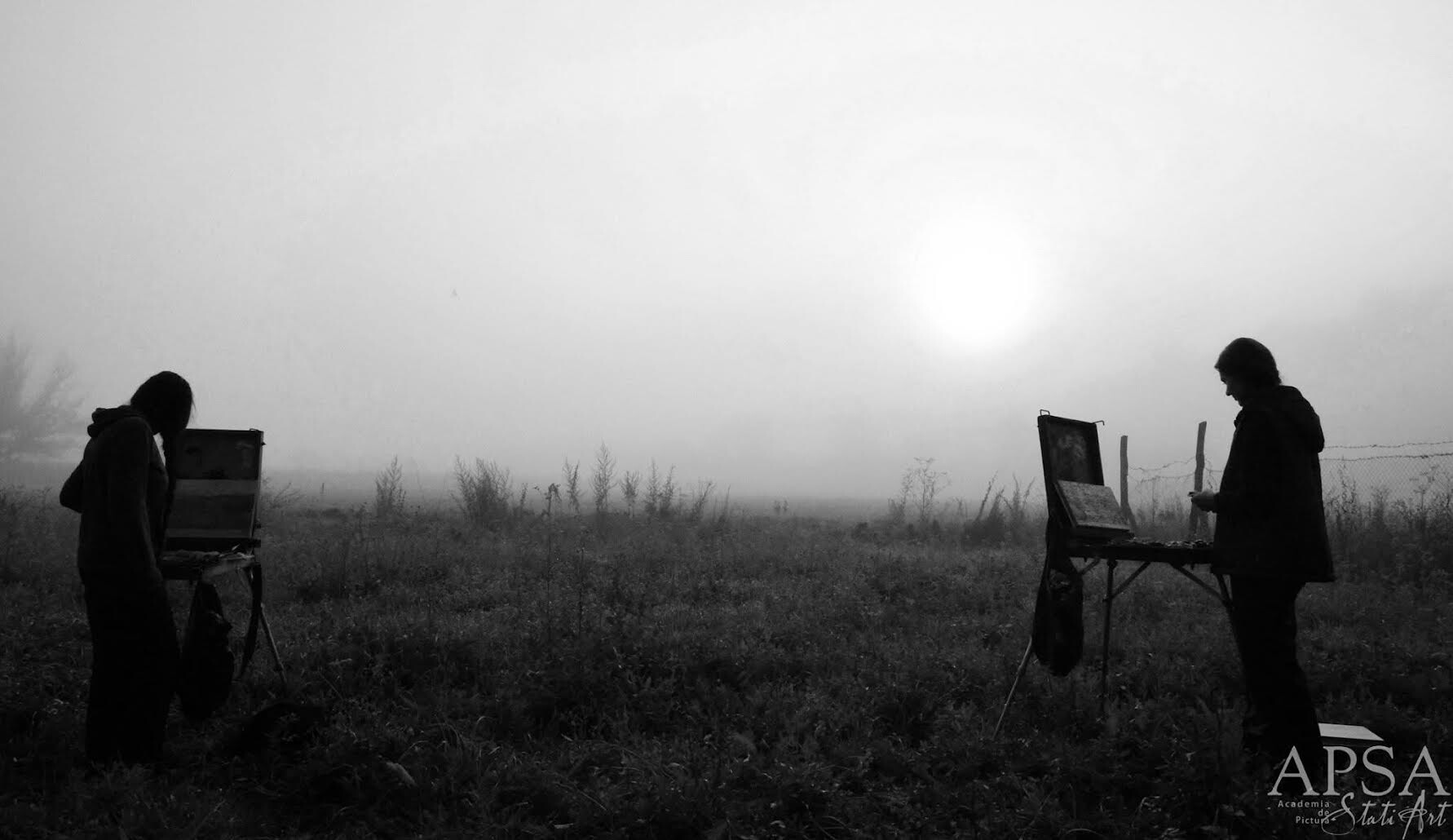 Archival photograph, 2016, Romania; two participants working at easels in a foggy field during an educational residential plein-air art programme.