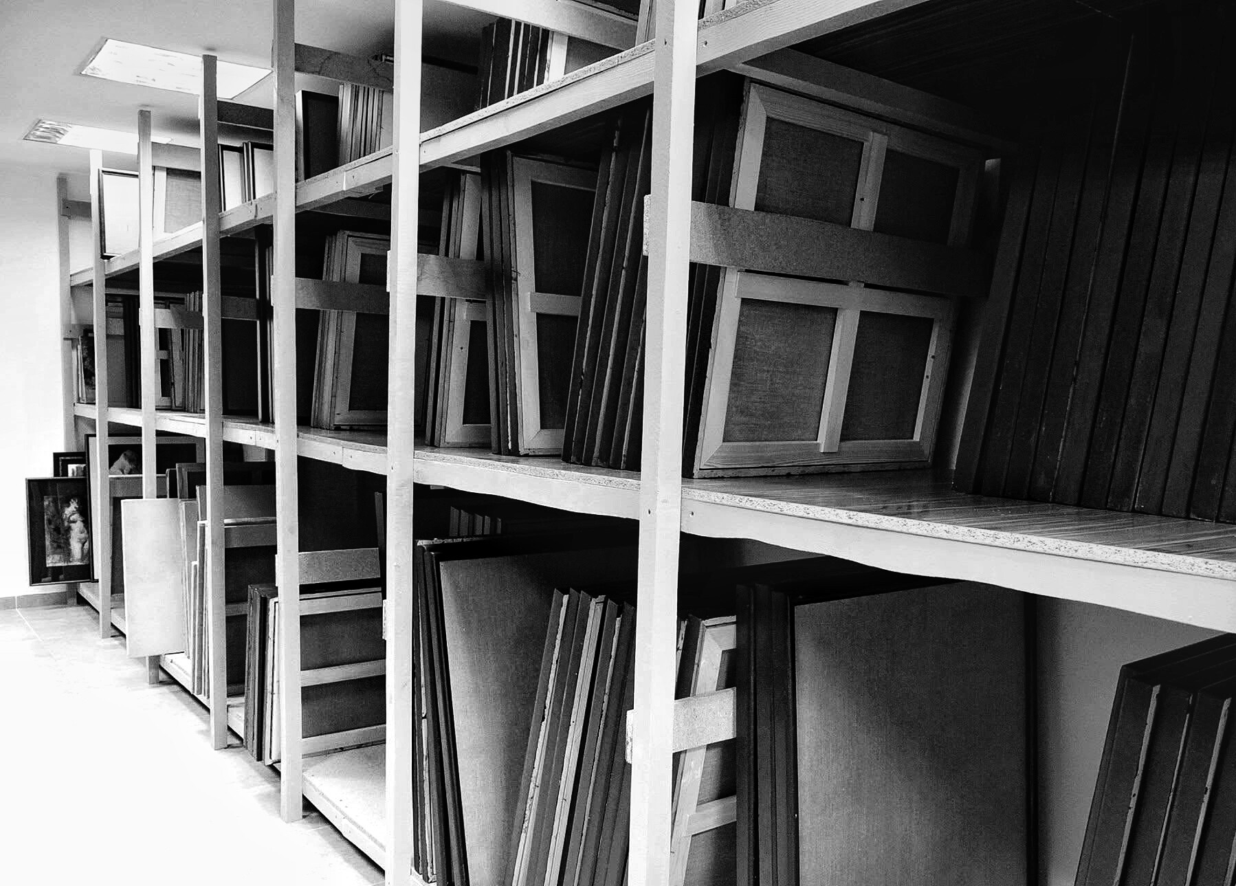 Archival photograph, 2016, APSA, Chișinău; storage racks filled with stretched and hand-prepared canvases in multiple formats.